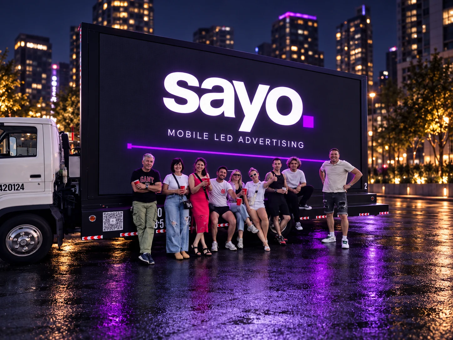 The Sayo team together beside the lit truck screen. Evening artwork based on our team photograph.